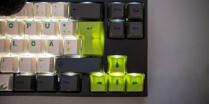 The backlight shines through green keycaps.