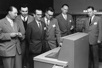 Lebedev (3rd from the left) eyeing up an IBM computer suspiciously.