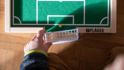 The goals are made of plastic; the football pitch is made of wood.