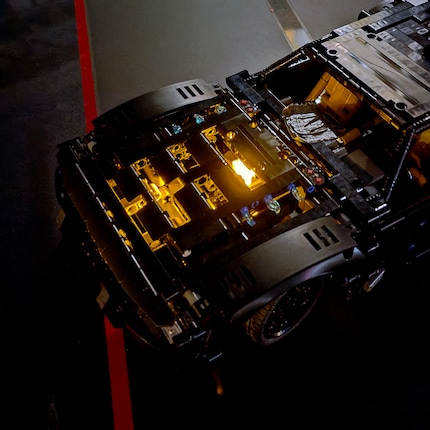The orange light brick illuminates the space under the hood.