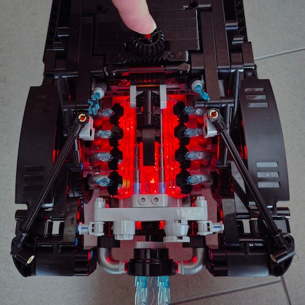 The rear engine lights up red when you press the steering knob on the roof.