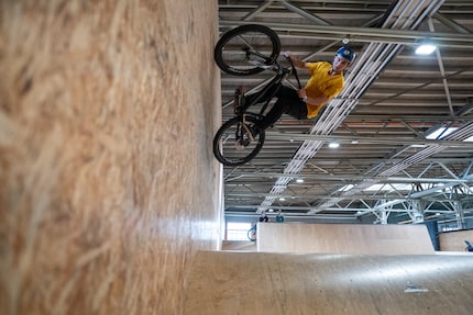 Out of nowhere, a biker is suddenly up on the wall.