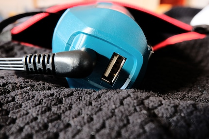 You wear the battery along with the jacket, which is why it has a USB port.