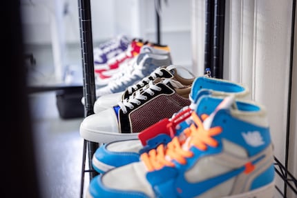 Shoes waiting to be dropped off or picked up take up an entire shelf.