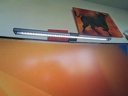 The screen bar’s LEDs illuminate the screen and desk from above.