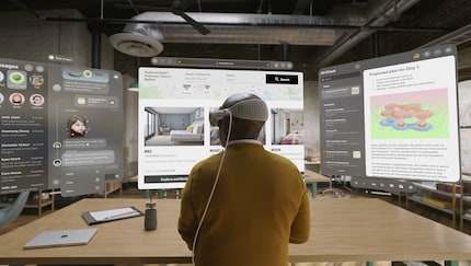 There’s room for real monitors in this office and the gentleman wouldn’t have to wear a headset all day.