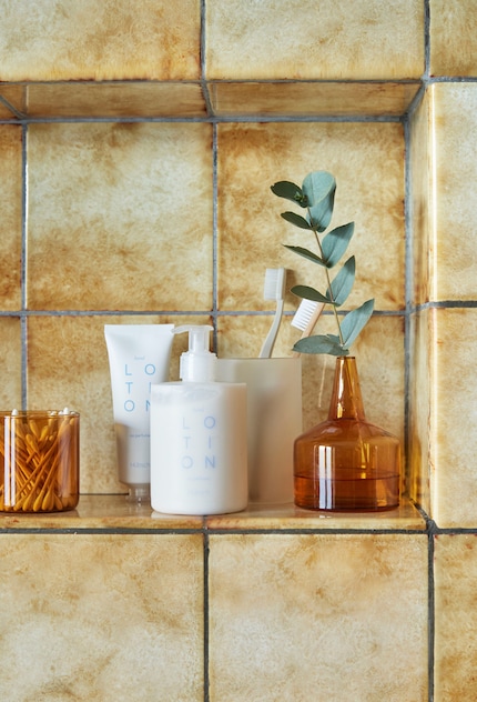 To pick up the colour of the tiles, vases from the same colour family were added in this example.