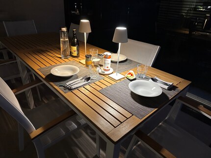 The Poldina Pro illuminates the patio table during a late family dinner.