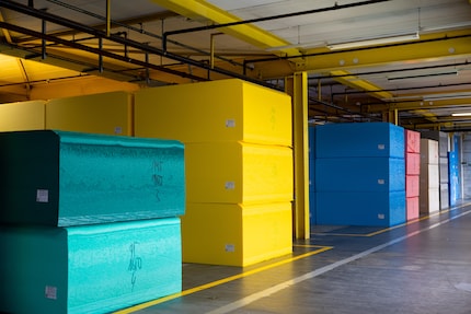Numerous brightly coloured foam blocks in the warehouse.