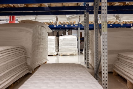 In the warehouse, hundreds of covers are waiting to be wrapped around foam cores.