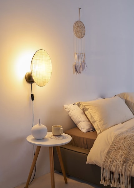 Instead of beaming light out into the room, the Boho Dream lamp keeps its glow on the wall.