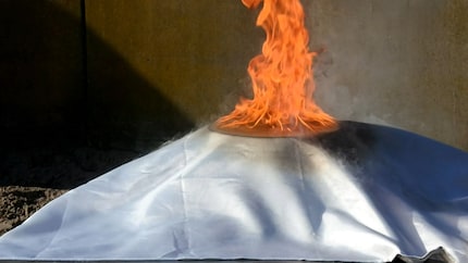 What a fire blanket must never do: burn.