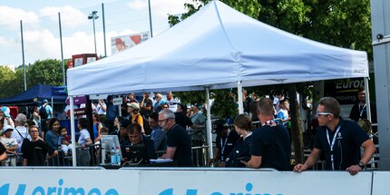 The commentators on the finish line keep us up to date on the race.