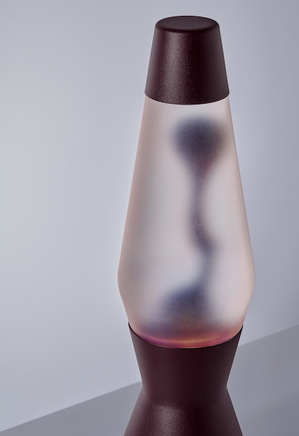 The frosted bottle creates a soft, warm light for the Bordeaux red lava.