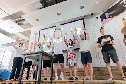 The winners of the Founders' Prize celebrating their prize – the Access 2000 manual from the Digitec founders. It’s kind of a challenge cup.