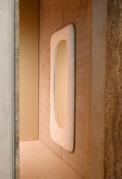 Stellar by Faye Toogood for Tacchini, wall mirror with wooden frame, covered with natural and paper fibres, 2024.