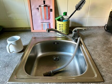 The drain hose goes in the sink. Remember that, Anika!