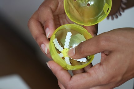 Steffi presse la fleur dans une capsule de gacha pour lui donner sa forme.