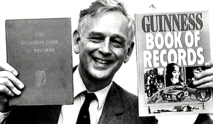 Brewery boss Beaver in 1955 with the first edition of the Guinness Book of Records.
