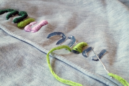 You can cover the raised letters with colourful thread.