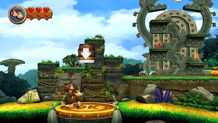 Après avoir tambouriné sur le terrain de Donkey Kong, un tonneau apparaît et me propulse dans la zone de fond du niveau.