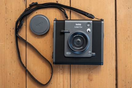 The camera is large, but comes with a neck strap and lens protection.