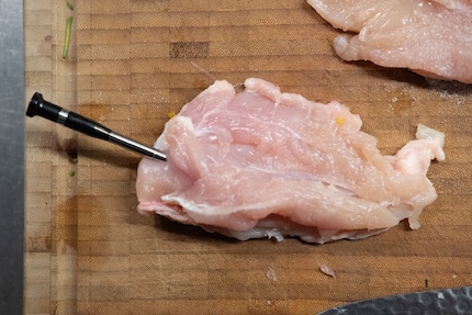 The probe should protrude enough from the meat so that its sensor can measure the ambient temperature.