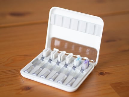 The Titanium model has six instead of three brush heads and comes with a futuristic storage box. 