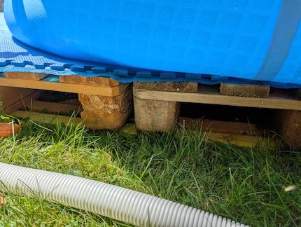 Use wood boards to even out the ground if necessary. Preferably before you fill up the pool with water.