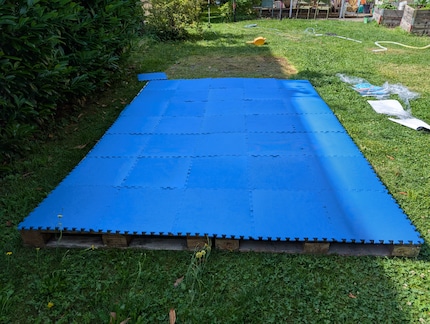 I placed a tarp under the mats. It previously served as a pool liner. However, I don’t think it made a big difference.