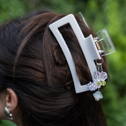 Stephanie has attached three colour-coordinated charm strands to one ring.