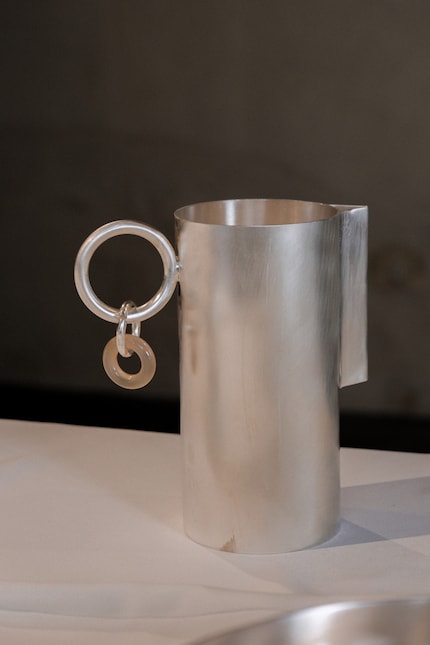 The carafe has a natural stone accent reminiscent of an earring.
