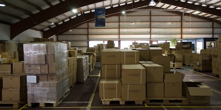 The company name appears all over the warehouse.