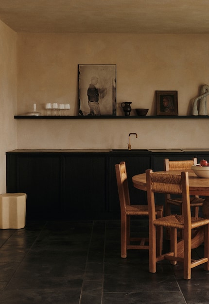 Modern kitchen paired with paintings from the flea market.